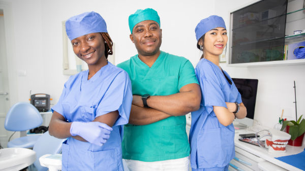 Dentist with Staff Talking About HR